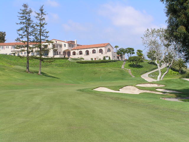 The 18th green at Riviera Country Club in Pacific Palisades, with the white Spanish-style clubhouse on the hill behind