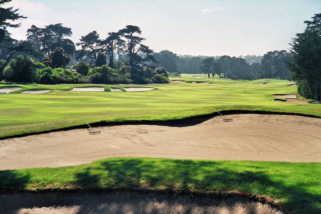 Rolling fairways and bold bunkering beneath Monterey cypress trees at San Francisco Golf Club