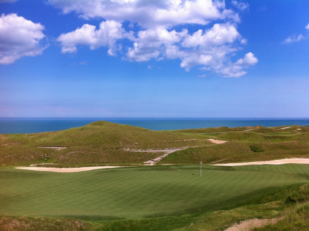 The shoreline 12th hole of the Irish Course at Whistling Straits, with dunes, bunkers and Lake Michigan beyond, in Kohler, Wisconsin