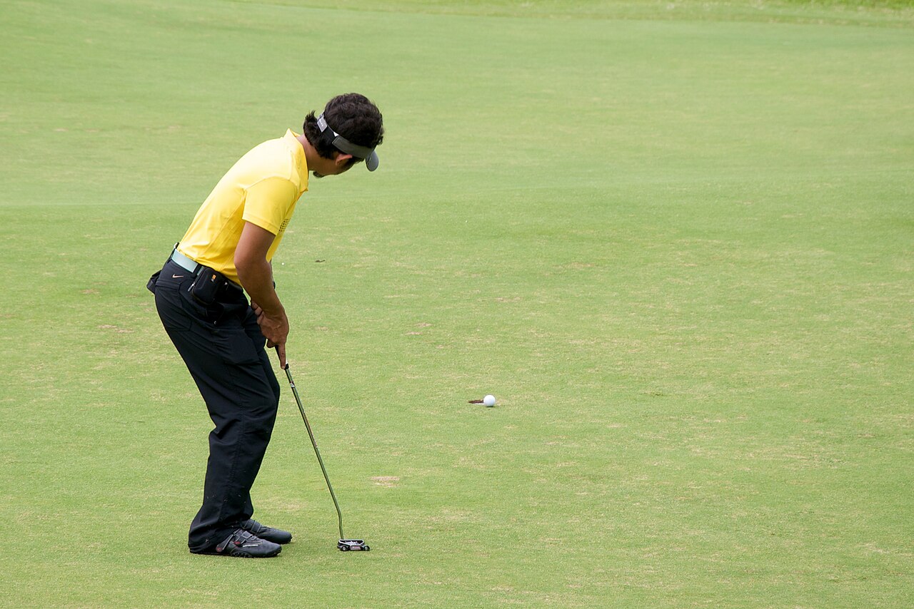 A golfer mid-swing during a round
